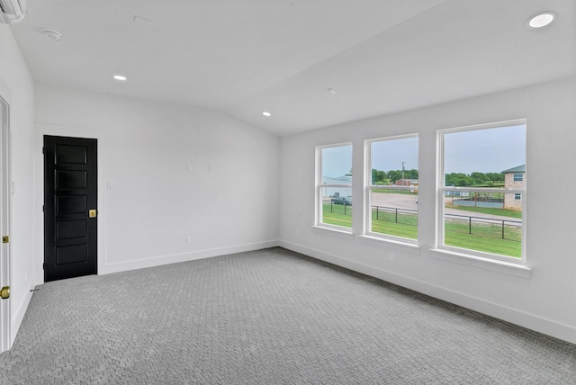 5360 Moncrief Rd, Justin, TX 76247 - carpeted spare room featuring baseboards, vaulted ceiling, recessed lighting, and an AC wall unit