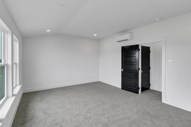 5360 Moncrief Rd, Justin, TX 76247 - carpeted spare room featuring plenty of natural light, a wall unit AC, vaulted ceiling, and recessed lighting