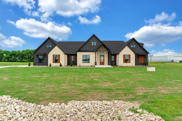 modern farmhouse featuring a front lawn