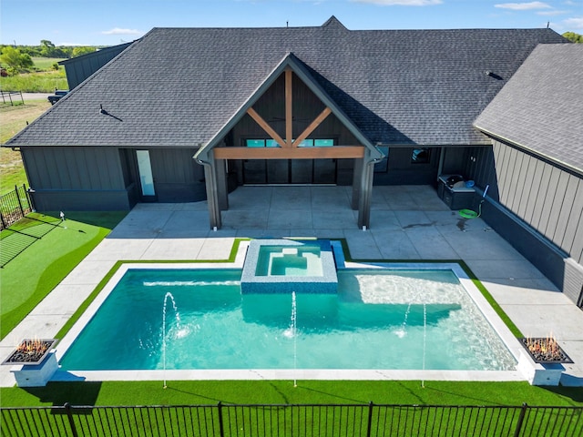 view of swimming pool with area for grilling, an in ground hot tub, a patio area, and pool water feature