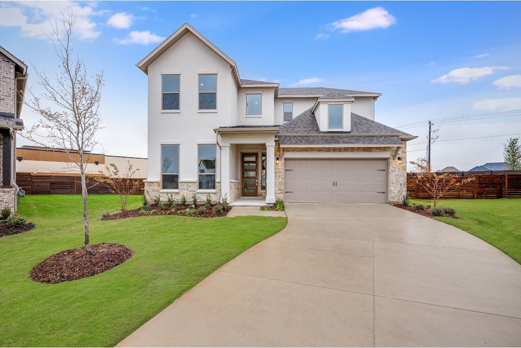 view of front of house featuring a front yard and a garage