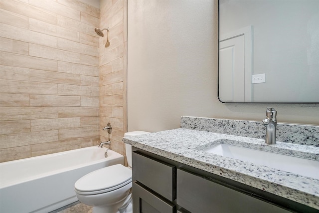 full bathroom featuring toilet, vanity, and tiled shower / bath combo