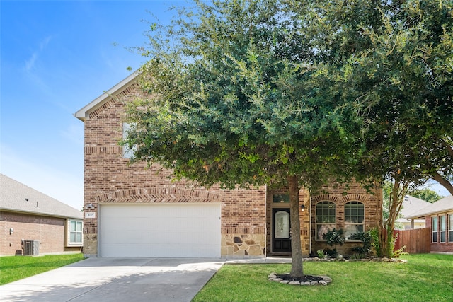 view of property hidden behind natural elements with a garage, central AC unit, and a front lawn