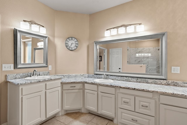 bathroom with tile patterned floors, vanity, and a shower