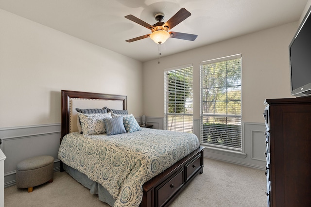 bedroom with light carpet and ceiling fan