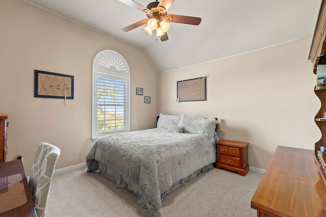 bedroom featuring ceiling fan, light carpet, and vaulted ceiling