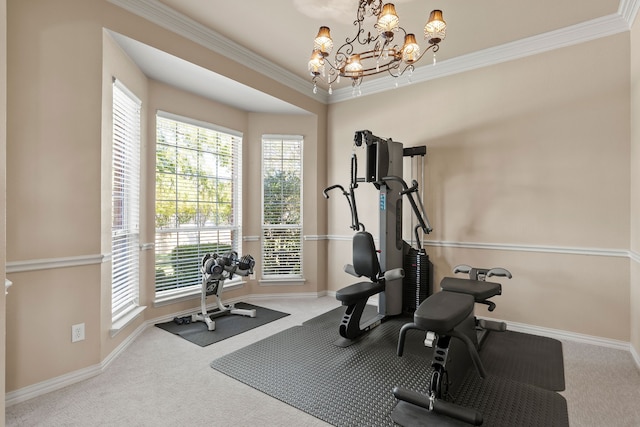 exercise room with carpet floors, crown molding, and an inviting chandelier