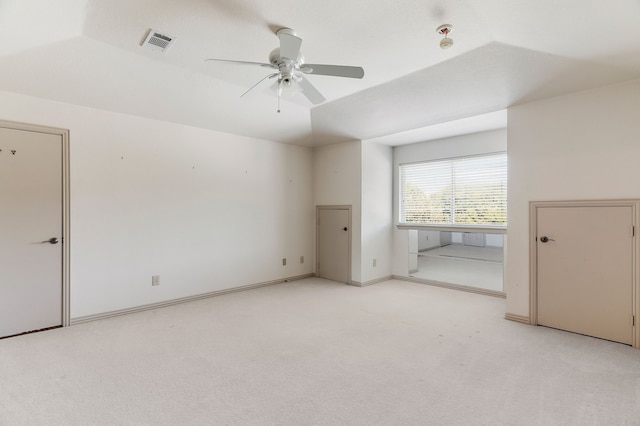 interior space with lofted ceiling, a closet, light colored carpet, and ceiling fan