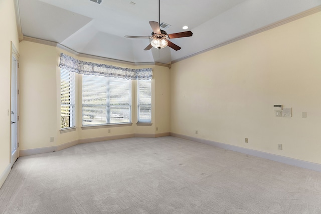 carpeted empty room with crown molding, a tray ceiling, and ceiling fan