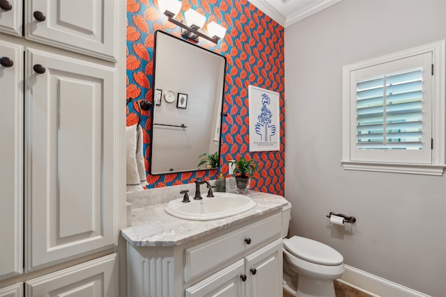 bathroom featuring ornamental molding, vanity, and toilet