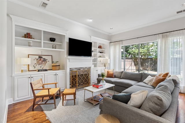 living room featuring wood-type flooring and crown molding