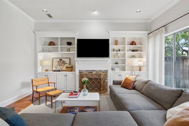 living room with wood-type flooring and ornamental molding