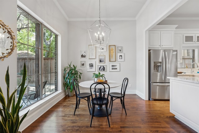 dining room with a notable chandelier, dark wood-type flooring, and crown molding