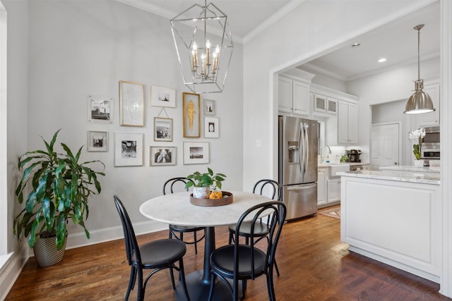 dining space with crown molding, dark hardwood / wood-style floors, and a chandelier