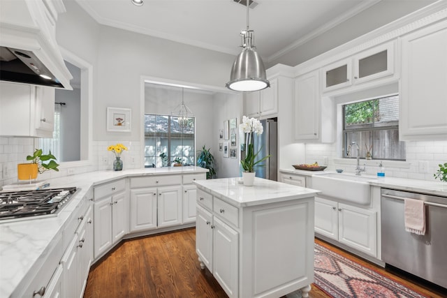 kitchen with white cabinets, appliances with stainless steel finishes, and tasteful backsplash