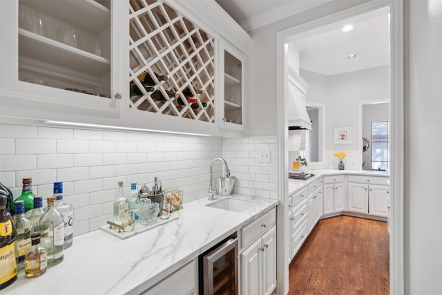 kitchen featuring sink, dark wood-type flooring, wine cooler, and white cabinets