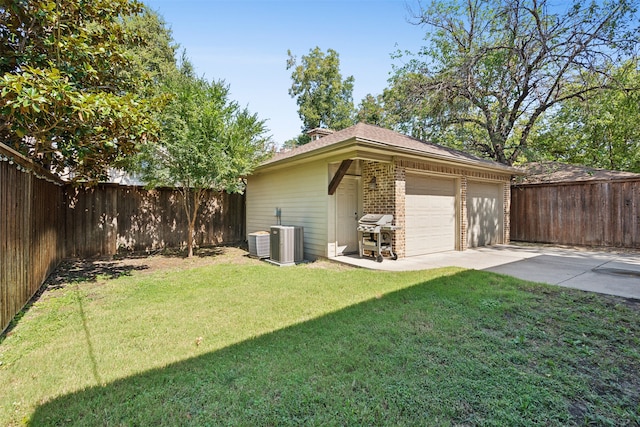 exterior space with wooden walls, a yard, and central air condition unit