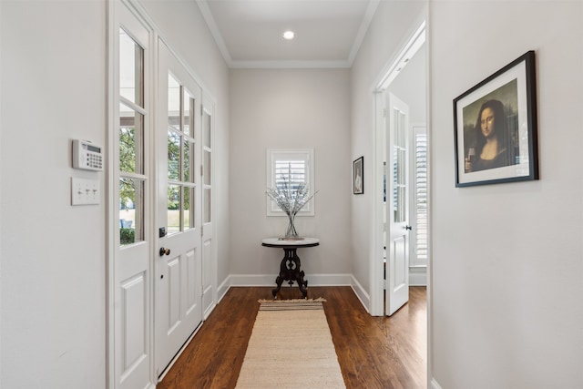 doorway with ornamental molding and dark hardwood / wood-style floors