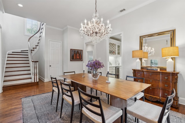 dining area with ornamental molding, beverage cooler, and dark hardwood / wood-style flooring