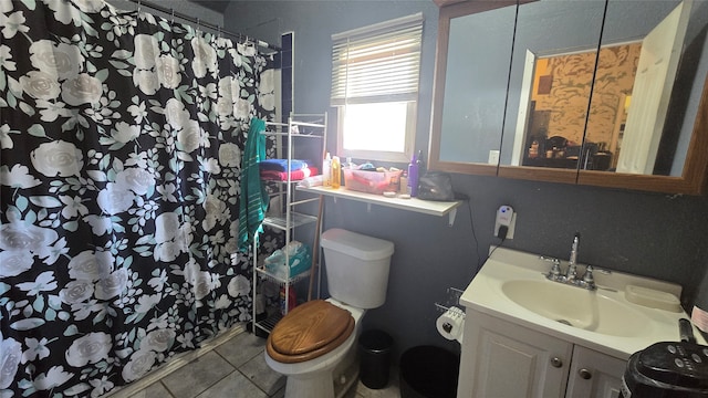 bathroom featuring tile patterned flooring, curtained shower, vanity, and toilet