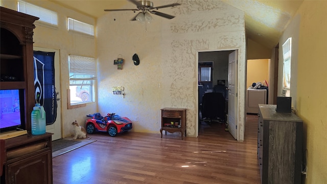 interior space featuring dark wood-type flooring, plenty of natural light, and vaulted ceiling