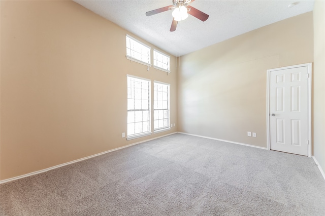 carpeted empty room with a textured ceiling and ceiling fan