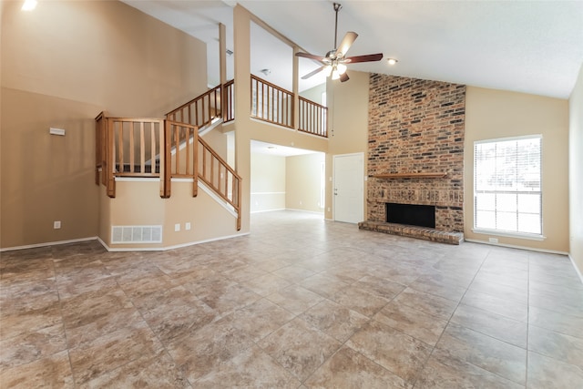 unfurnished living room featuring a brick fireplace, high vaulted ceiling, and ceiling fan