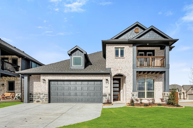 view of front of house with a garage, a balcony, and a front yard