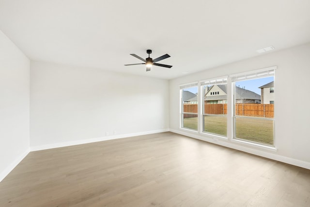 spare room with light hardwood / wood-style flooring and ceiling fan