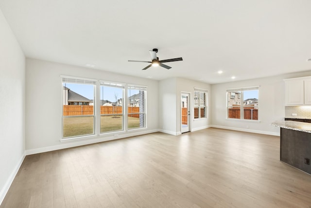 unfurnished living room with ceiling fan and light hardwood / wood-style flooring