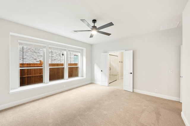 unfurnished bedroom featuring ceiling fan and light carpet