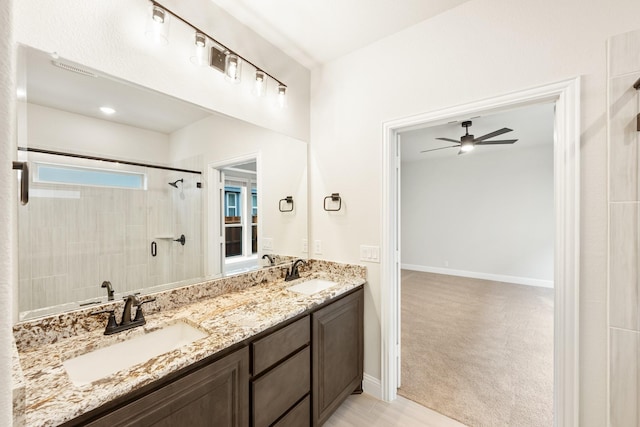 bathroom with vanity, a shower, and ceiling fan