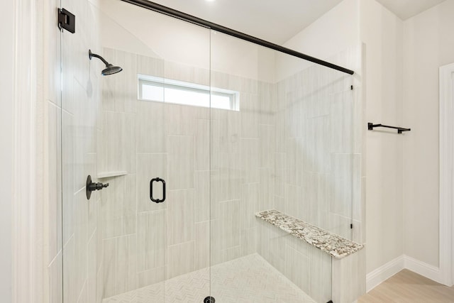 bathroom with a shower with door