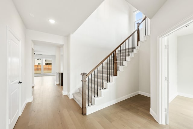 staircase with hardwood / wood-style floors