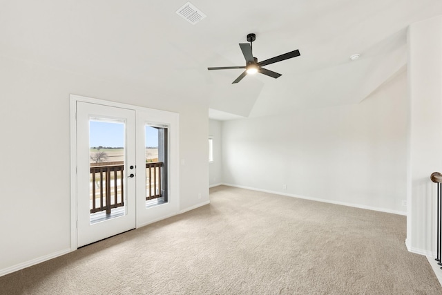 carpeted spare room with vaulted ceiling and ceiling fan