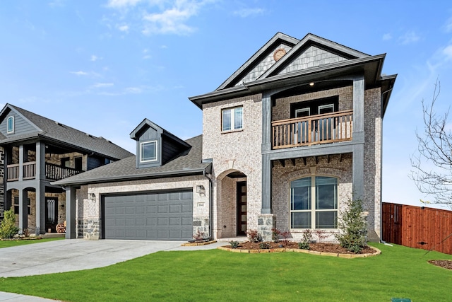 view of front of property featuring a garage, a balcony, and a front yard