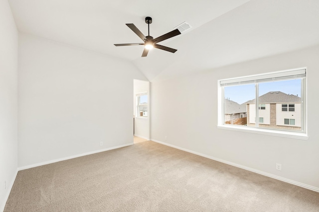 carpeted empty room with ceiling fan and lofted ceiling