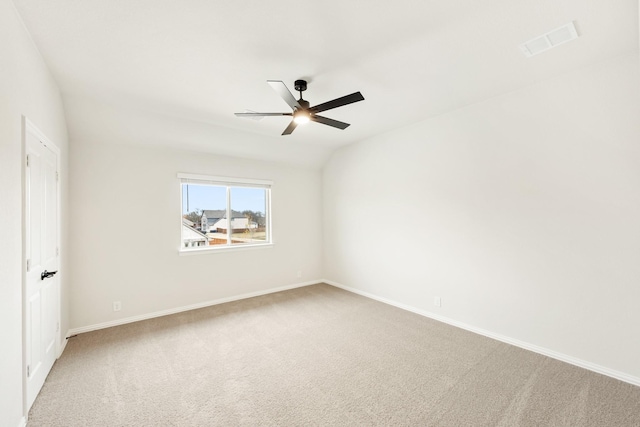 carpeted spare room with ceiling fan