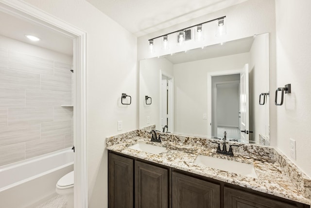 full bathroom featuring vanity, toilet, and tiled shower / bath combo