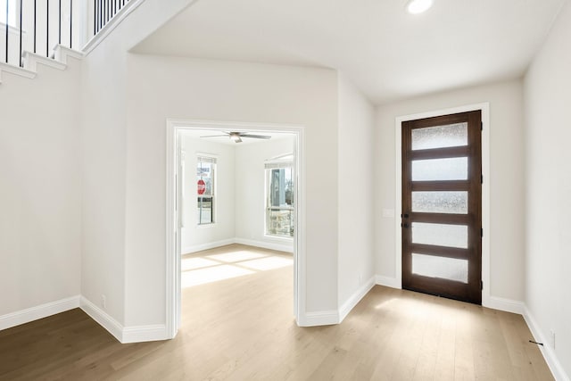 entryway with ceiling fan and light hardwood / wood-style flooring