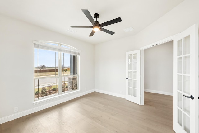 spare room featuring ceiling fan, light hardwood / wood-style flooring, and french doors