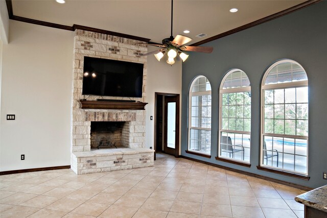 7226 County Road 1504, Athens, TX 75751 - unfurnished living room with ornamental molding, ceiling fan, recessed lighting, a stone fireplace, and tile patterned flooring