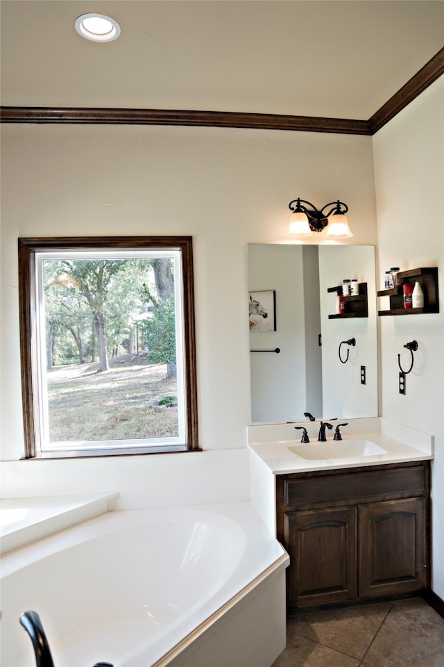 bathroom with crown molding, a bathing tub, tile patterned flooring, and vanity