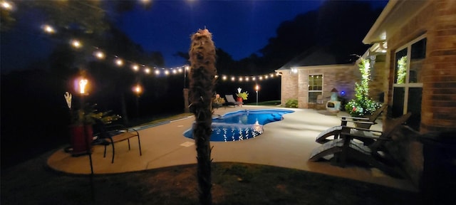 7226 County Road 1504, Athens, TX 75751 - pool at night with a patio and an outdoor pool