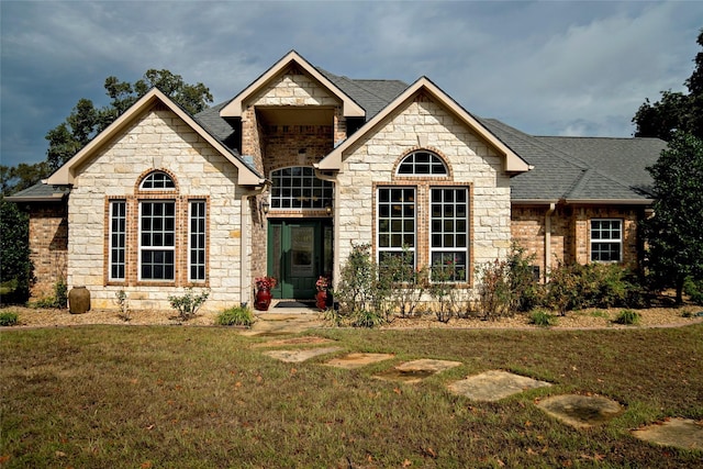 7226 County Road 1504, Athens, TX 75751 - view of front of property featuring stone siding, a front lawn, and a shingled roof