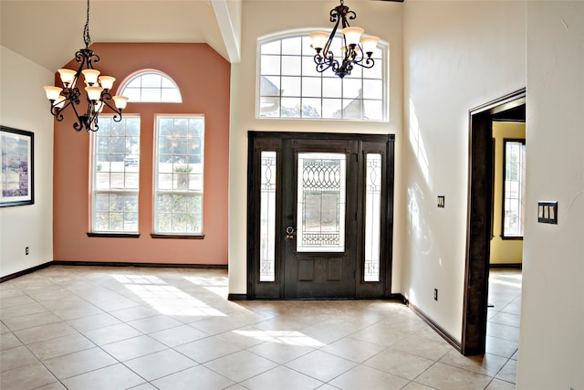 tiled entrance foyer with a notable chandelier and high vaulted ceiling