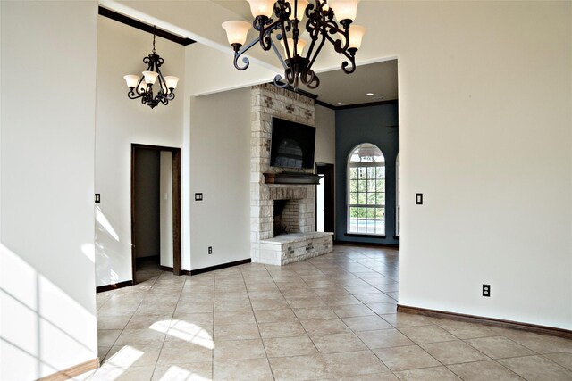 7226 County Road 1504, Athens, TX 75751 - unfurnished living room featuring a chandelier, baseboards, a fireplace, light tile patterned floors, and a towering ceiling