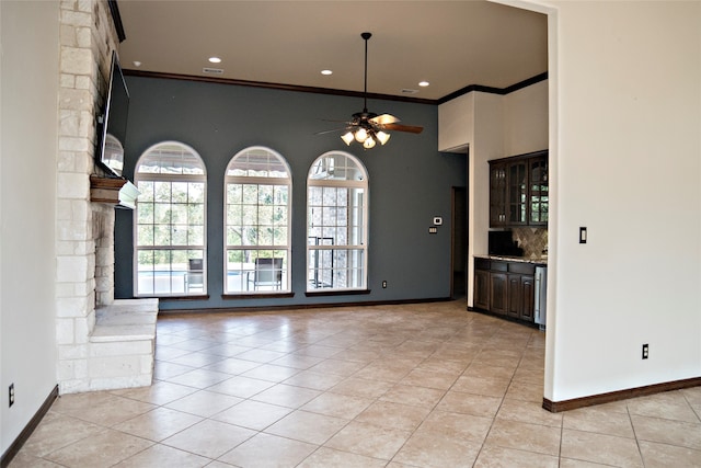 interior space featuring ornamental molding, ceiling fan, and light tile patterned floors