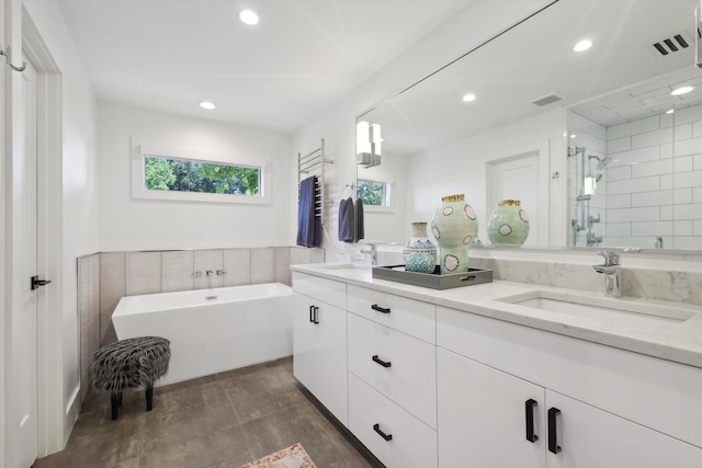 bathroom featuring vanity and separate shower and tub