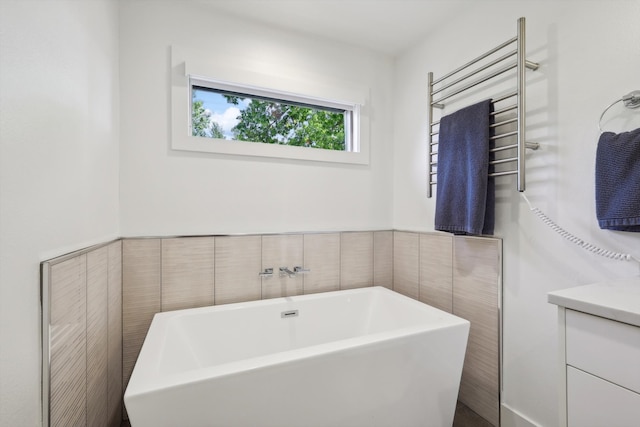 bathroom with vanity and a bath